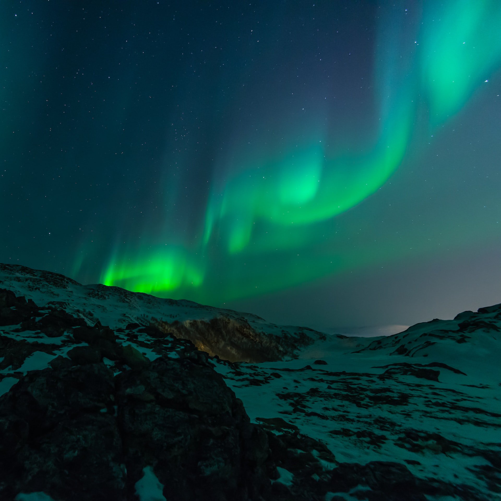 Photo of Aurora in the mountains courtesy of Unsplash.
