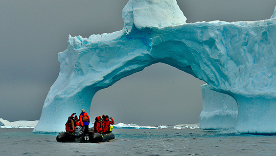 Photo of glacier and people on raft